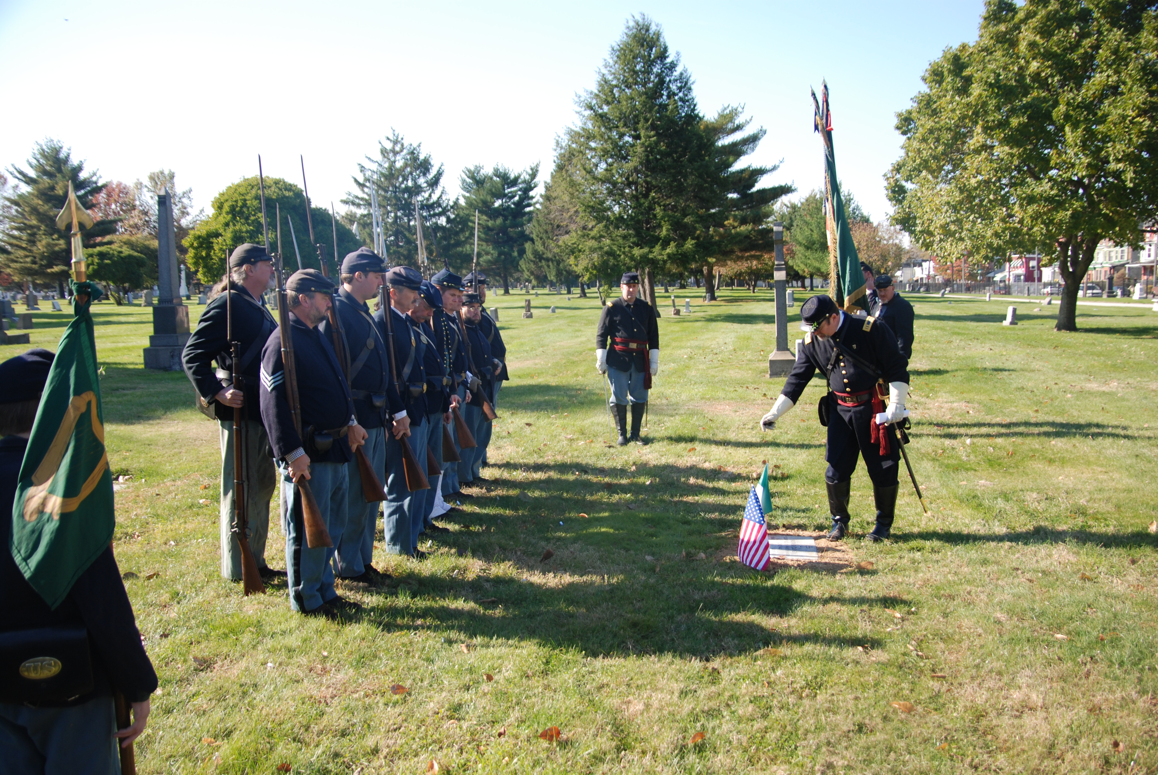 Soil brought back from Ireland is placed upon each grave